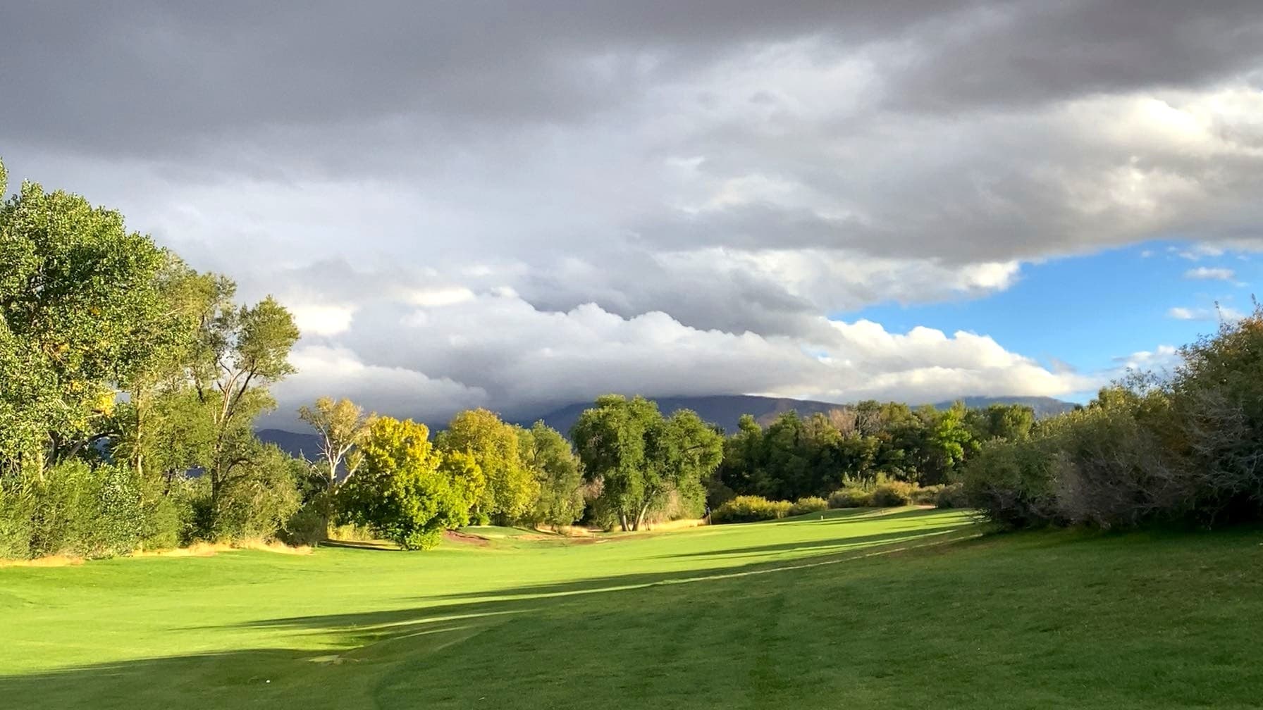 Pistol Rock Golf Course pond and fairway with the Pahvant Range in the distance