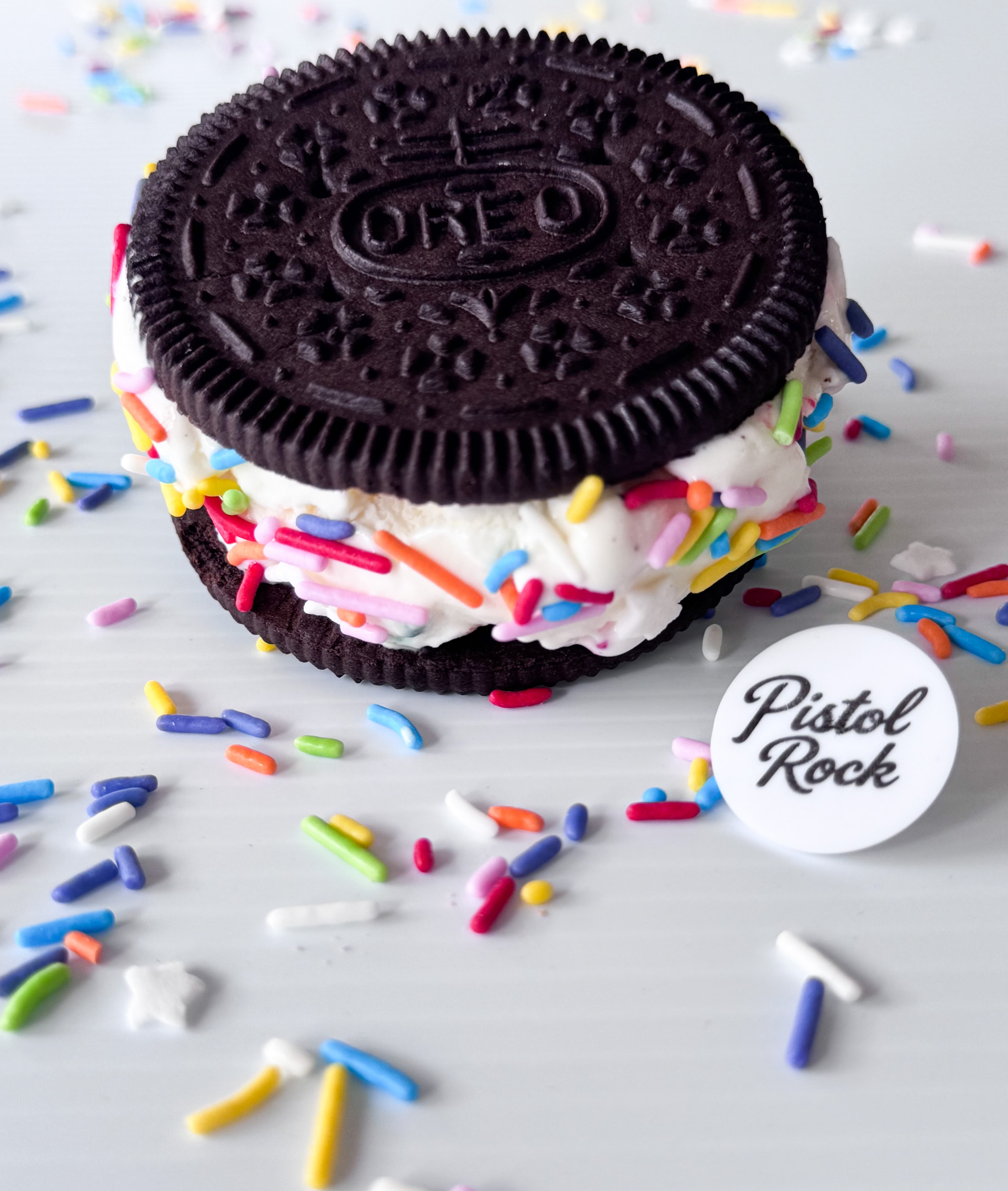 An Oreo Wafer ice cream sandwich rolled in rainbow sprinkles